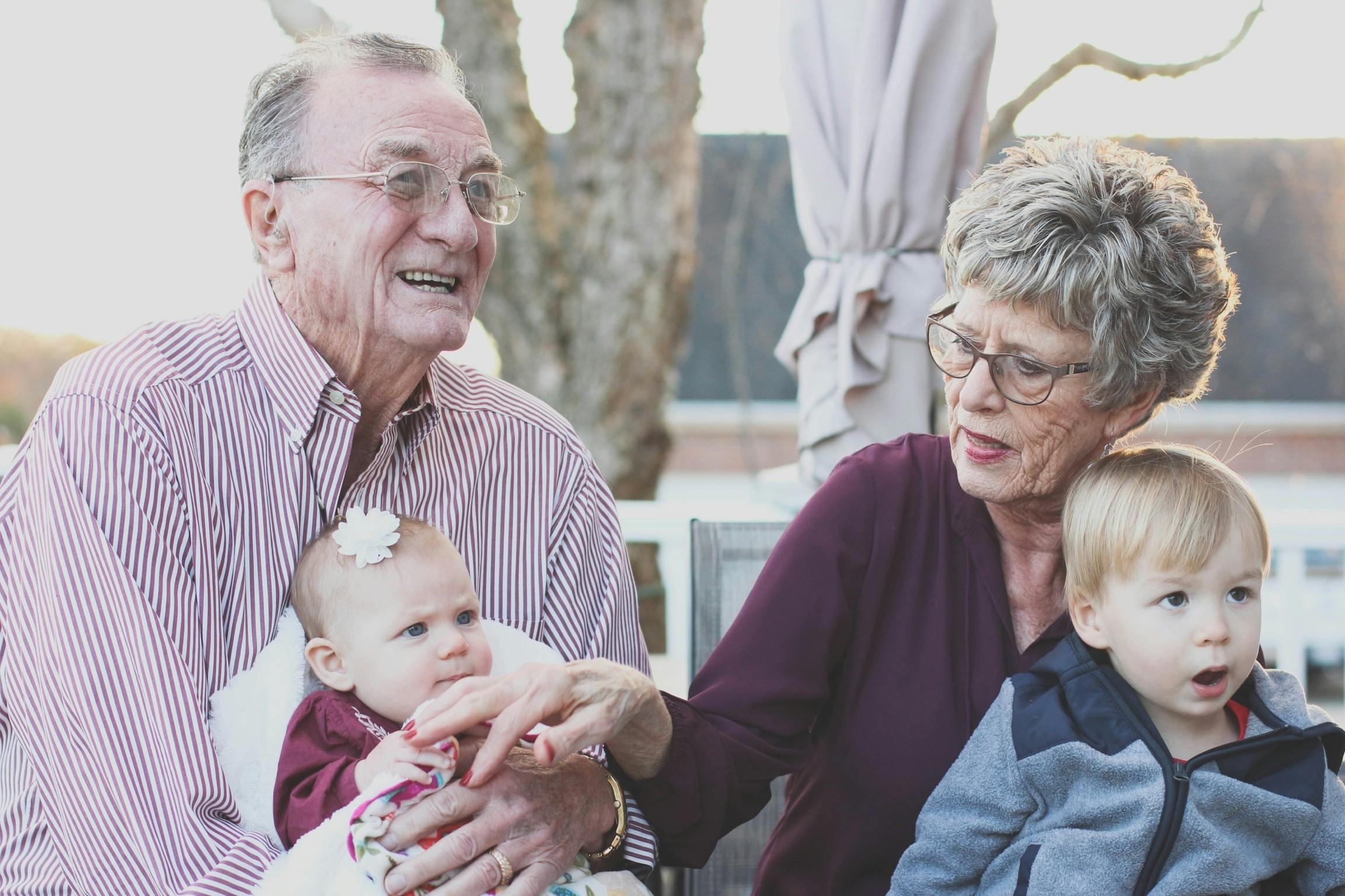 Grandparents reading personalised family newspaper with grandchildren